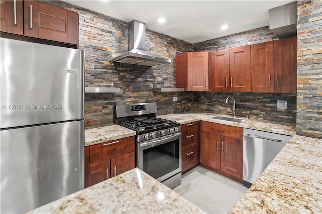 kitchen with stainless steel appliances, wall chimney exhaust hood, sink, light stone countertops, and backsplash