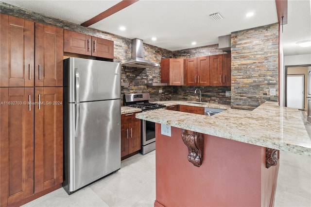 kitchen featuring kitchen peninsula, wall chimney exhaust hood, appliances with stainless steel finishes, light tile patterned floors, and backsplash