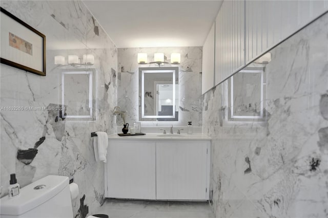 bathroom featuring tile walls, vanity, and toilet