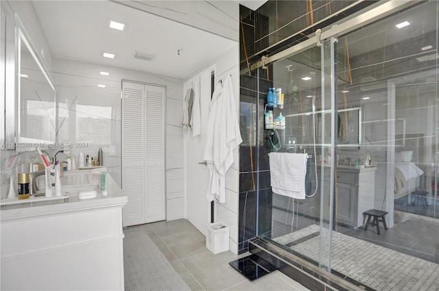 bathroom with tile patterned floors, an enclosed shower, and vanity