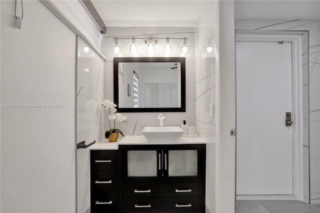 bathroom featuring vanity and tasteful backsplash