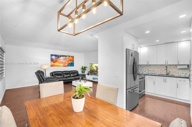 dining space with hardwood / wood-style flooring and sink