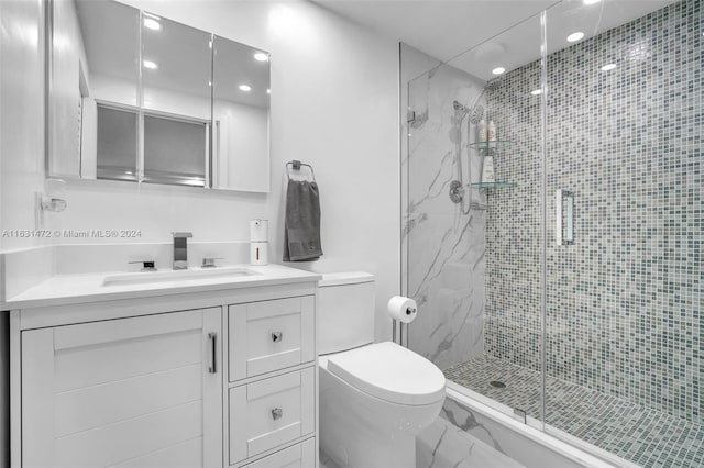 bathroom featuring a shower with shower door, toilet, and vanity