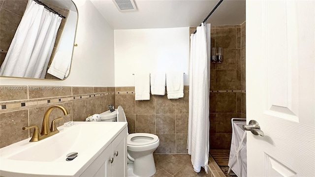 full bathroom featuring toilet, visible vents, vanity, a shower stall, and tile patterned floors