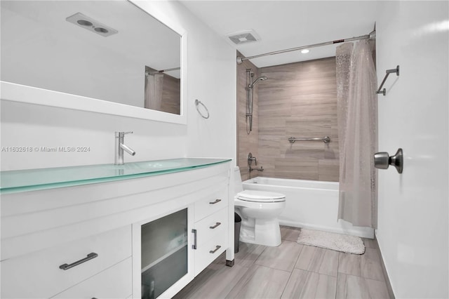 full bathroom featuring shower / bath combo, vanity, and toilet