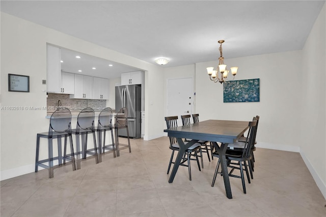 tiled dining area featuring a notable chandelier