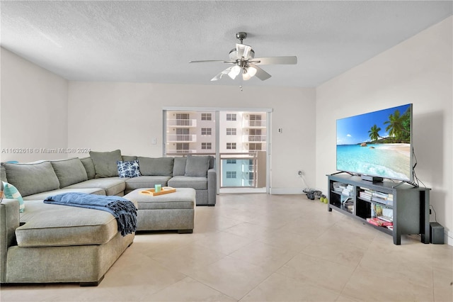 living room featuring a textured ceiling and ceiling fan