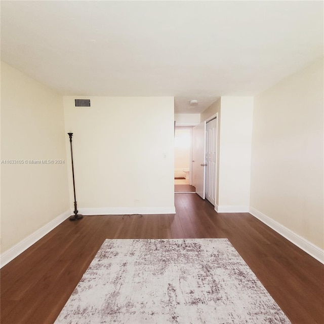 spare room with dark hardwood / wood-style flooring