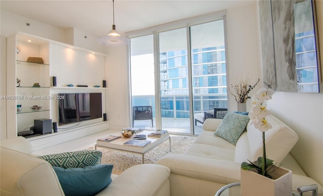 living room with tile patterned flooring and floor to ceiling windows