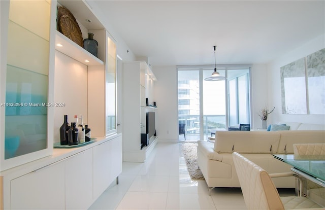 tiled living room with floor to ceiling windows