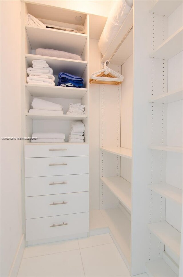 spacious closet featuring light tile patterned floors