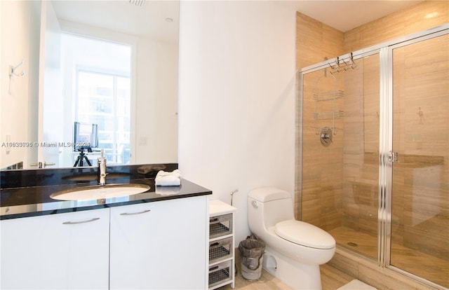 bathroom with walk in shower, toilet, and vanity