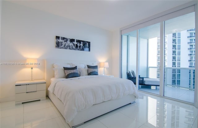 bedroom with light tile patterned floors, access to exterior, and expansive windows