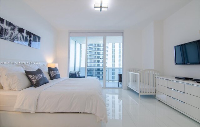 bedroom with expansive windows and light tile patterned floors