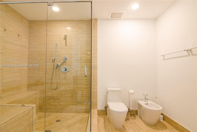 bathroom with a bidet, an enclosed shower, and toilet