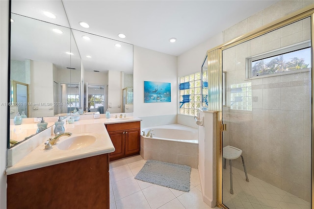 bathroom with tile patterned flooring, shower with separate bathtub, and dual vanity