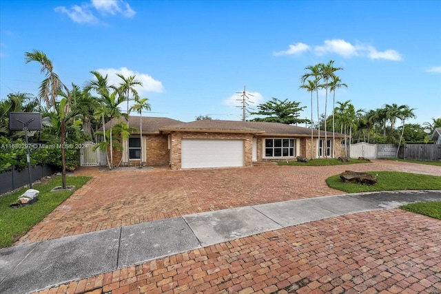 ranch-style house with a garage and a front lawn