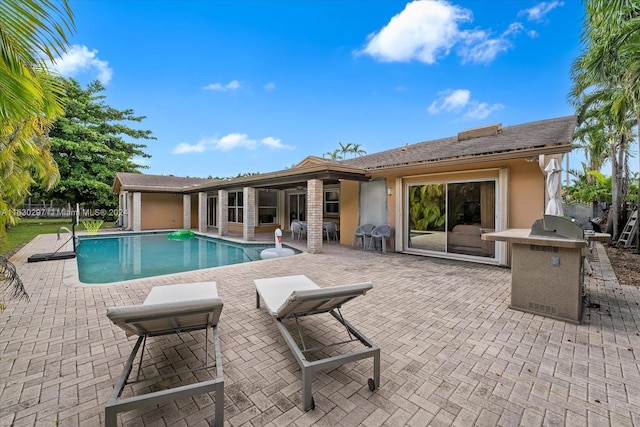 view of pool featuring a patio area and a grill