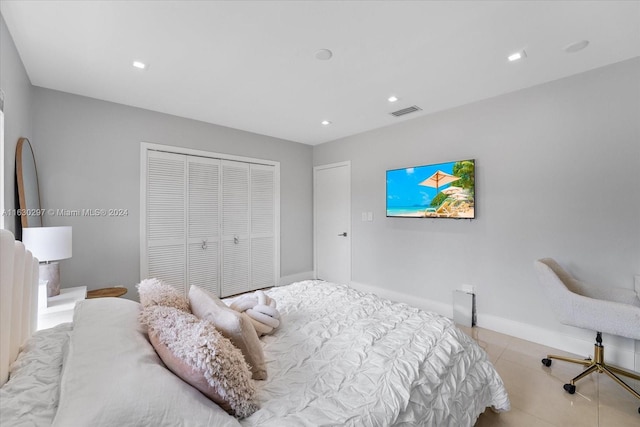 bedroom featuring a closet and light tile patterned floors