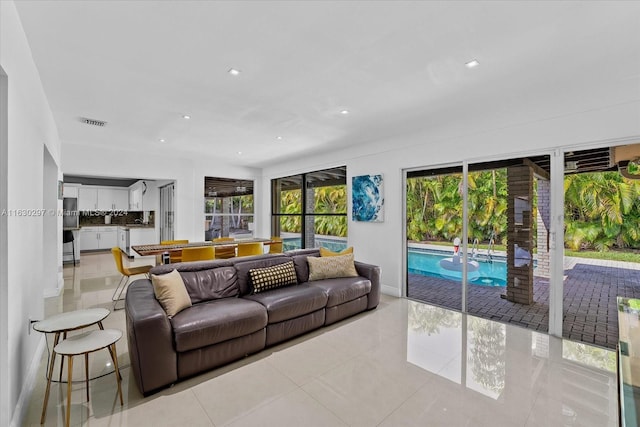 living room featuring light tile patterned floors and plenty of natural light