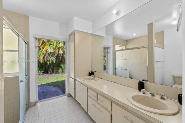 bathroom featuring vanity, walk in shower, and tile patterned floors