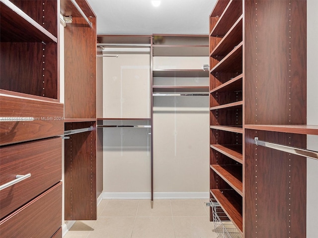 spacious closet featuring light tile patterned floors