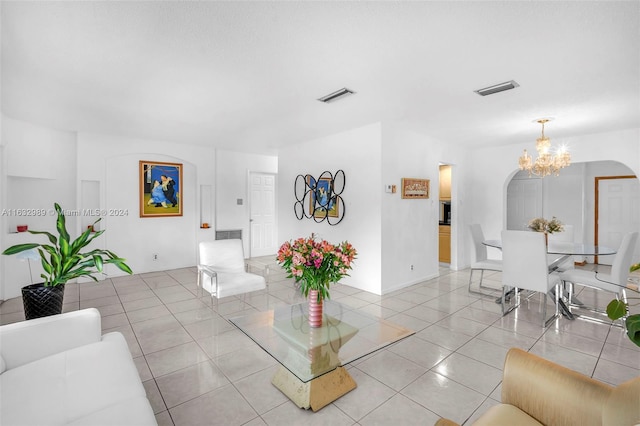 living room with an inviting chandelier and light tile patterned floors