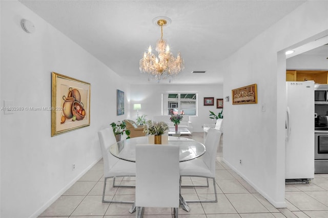 tiled dining space with a chandelier