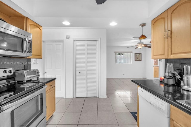 kitchen with light tile patterned flooring, light brown cabinetry, ceiling fan, appliances with stainless steel finishes, and backsplash