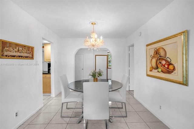 tiled dining area featuring an inviting chandelier