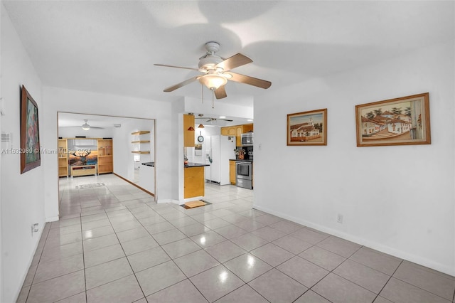 tiled empty room featuring ceiling fan