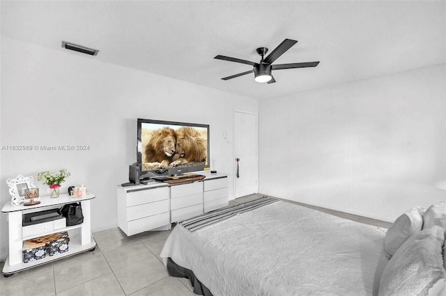 tiled bedroom featuring ceiling fan