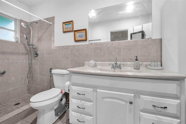 bathroom featuring vanity, tile walls, toilet, tile patterned flooring, and backsplash