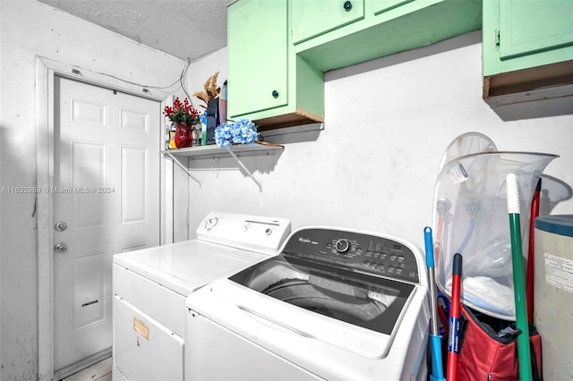 laundry room featuring cabinets, a textured ceiling, and independent washer and dryer