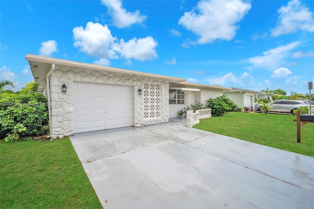 ranch-style home with a garage and a front yard