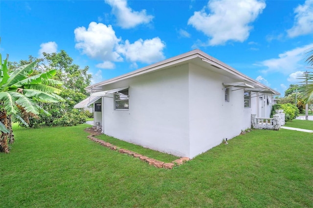 view of side of property with a yard