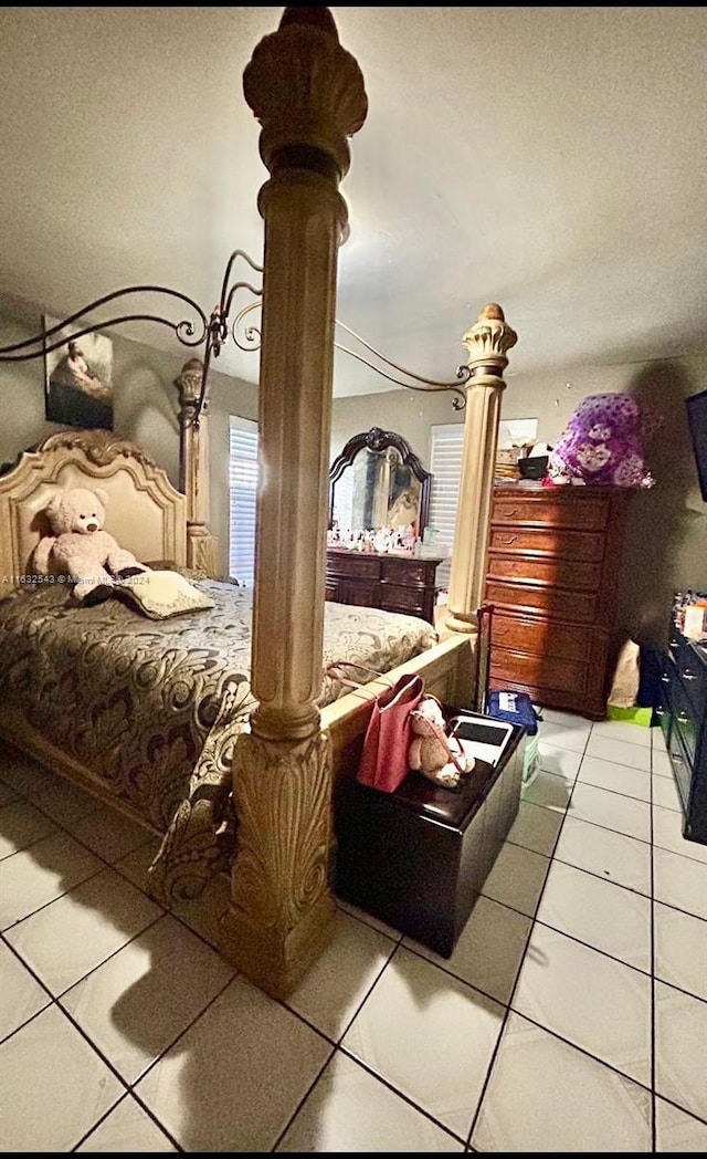 tiled bedroom featuring ornate columns