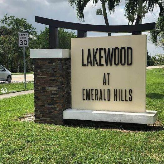 community / neighborhood sign with a lawn