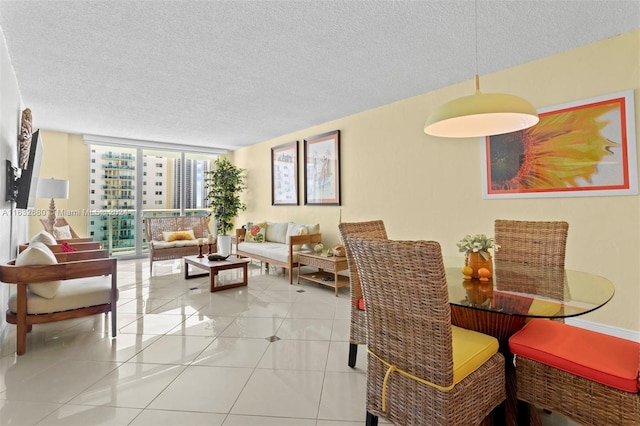 dining area with floor to ceiling windows, light tile patterned floors, and a textured ceiling