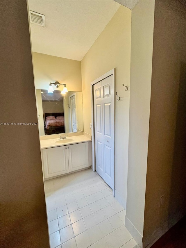 bathroom with tile patterned floors and vanity