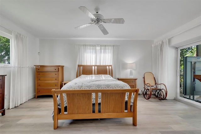 bedroom featuring light wood-type flooring, ceiling fan, and access to outside