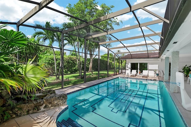 outdoor pool featuring glass enclosure and a patio