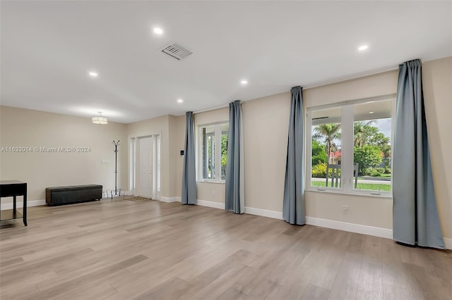 interior space featuring light wood-type flooring, visible vents, baseboards, and recessed lighting