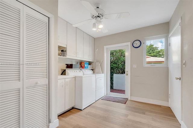 washroom with a ceiling fan, washing machine and dryer, cabinet space, light wood finished floors, and baseboards