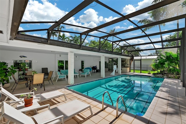 pool featuring a lanai, outdoor lounge area, and a patio area