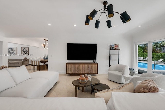 living room with light colored carpet and a notable chandelier