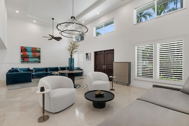 living room with an inviting chandelier and a towering ceiling