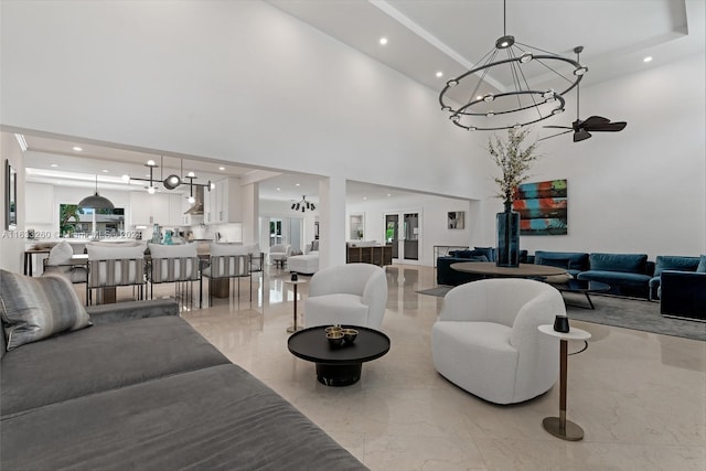 living room featuring a chandelier and a high ceiling