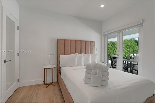 bedroom with light hardwood / wood-style floors, french doors, and access to exterior