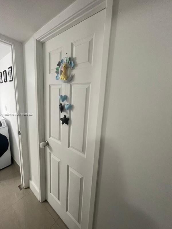 room details featuring washer / clothes dryer and tile patterned floors